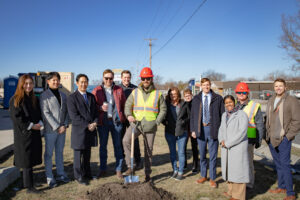 people standing in front of a shovel