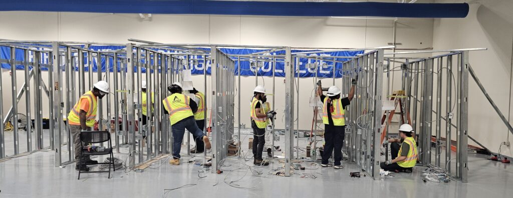 electrician trainees wire walls