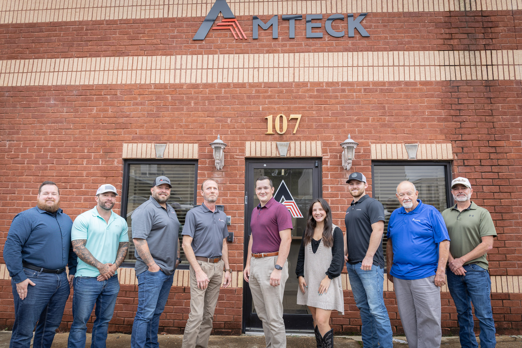 a group of people in front of an brick building