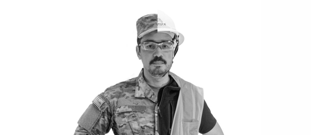 man half dressed in military fatigues and half dressed as a construction worker